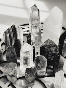 A collection of polished crystals glowing softly on a mossy surface.