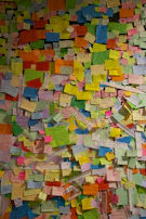 A wall of handwritten notes and memories left by visitors, creating a tapestry of shared healing.