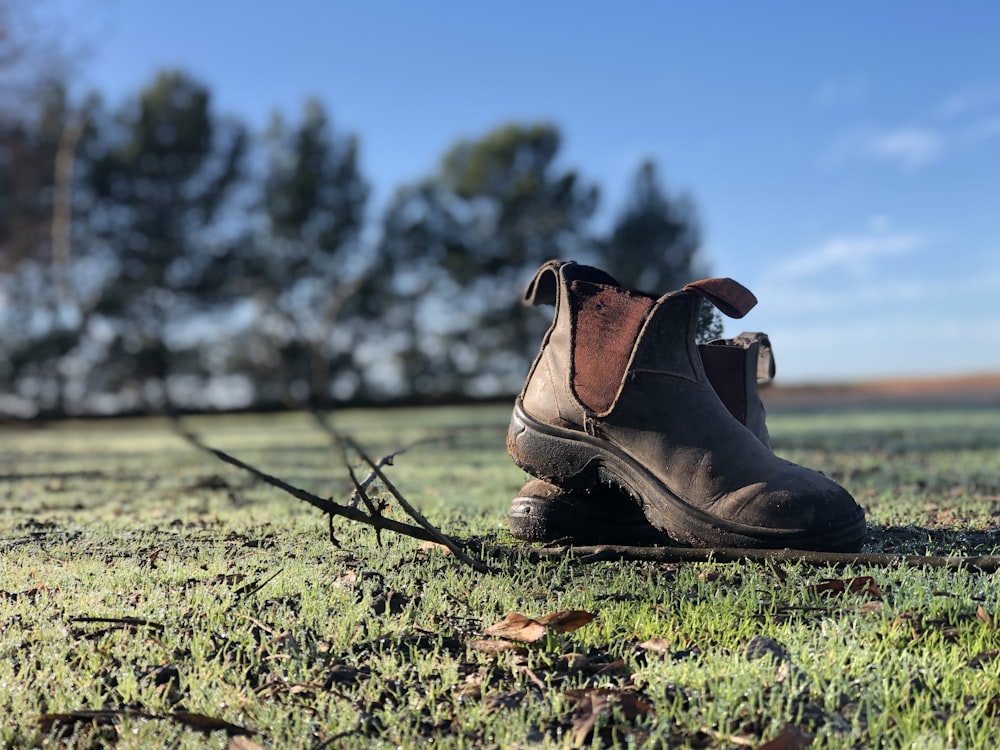 brown leather boots on green grass during daytime