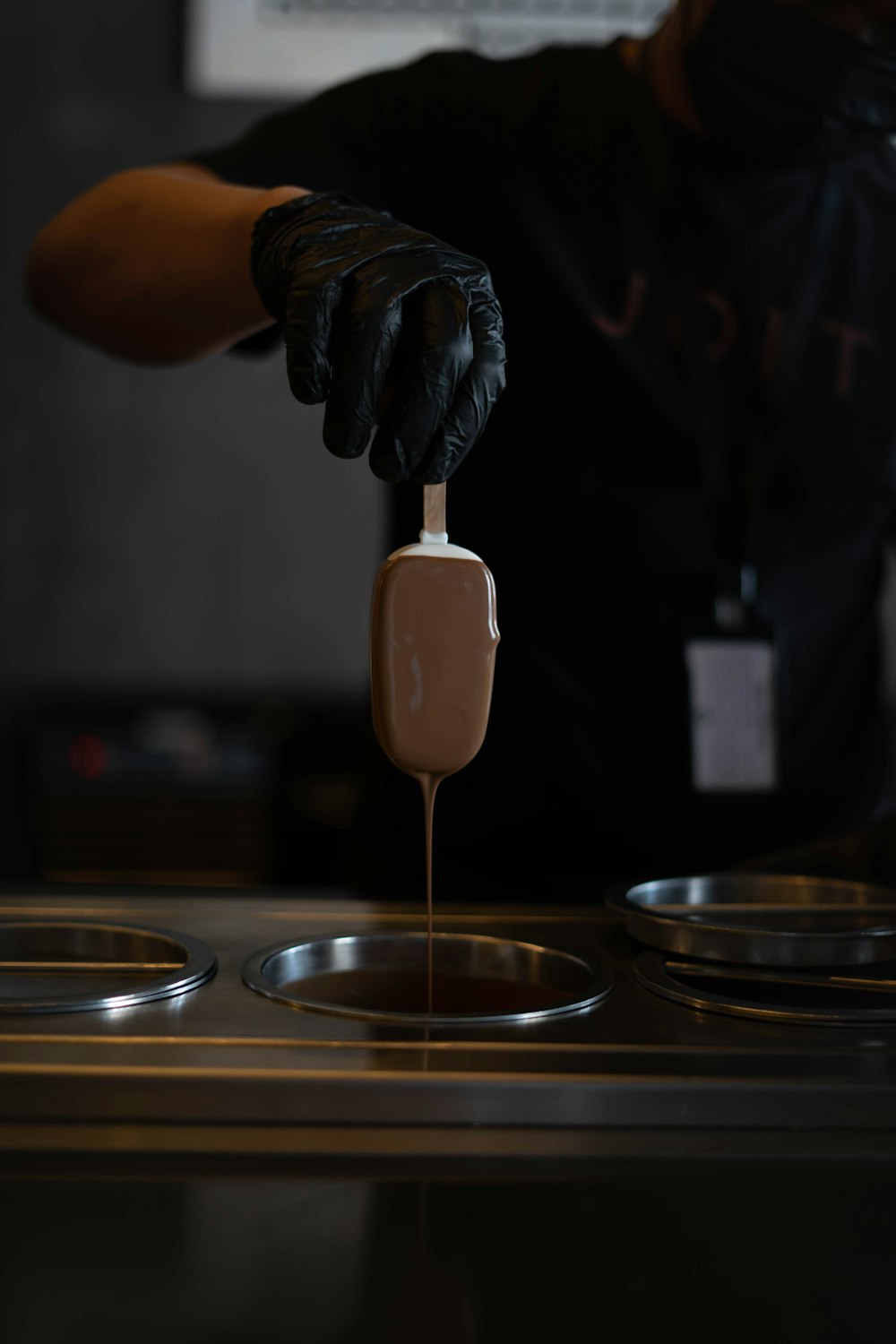 person holding brown wooden spoon