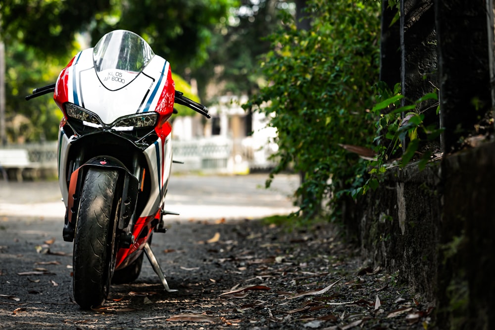 black and red motorcycle parked on the side of the road