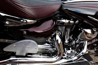 Close-up of a motorcycle engine with chrome details shining under sunlight