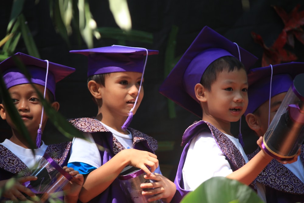 boy in academic gown standing beside girl in academic dress