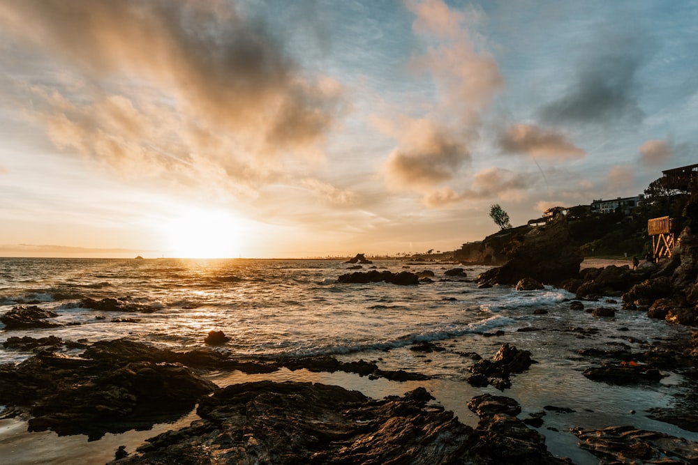 ocean waves crashing on rocks during sunset