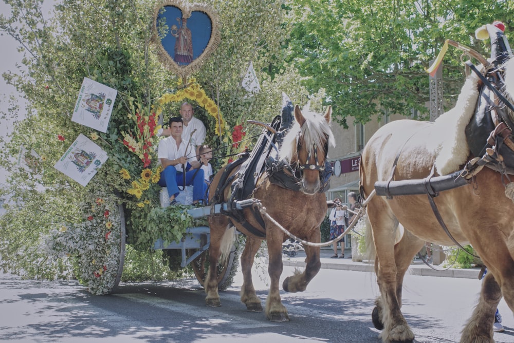 white horse with brown leather saddle on the street during daytime