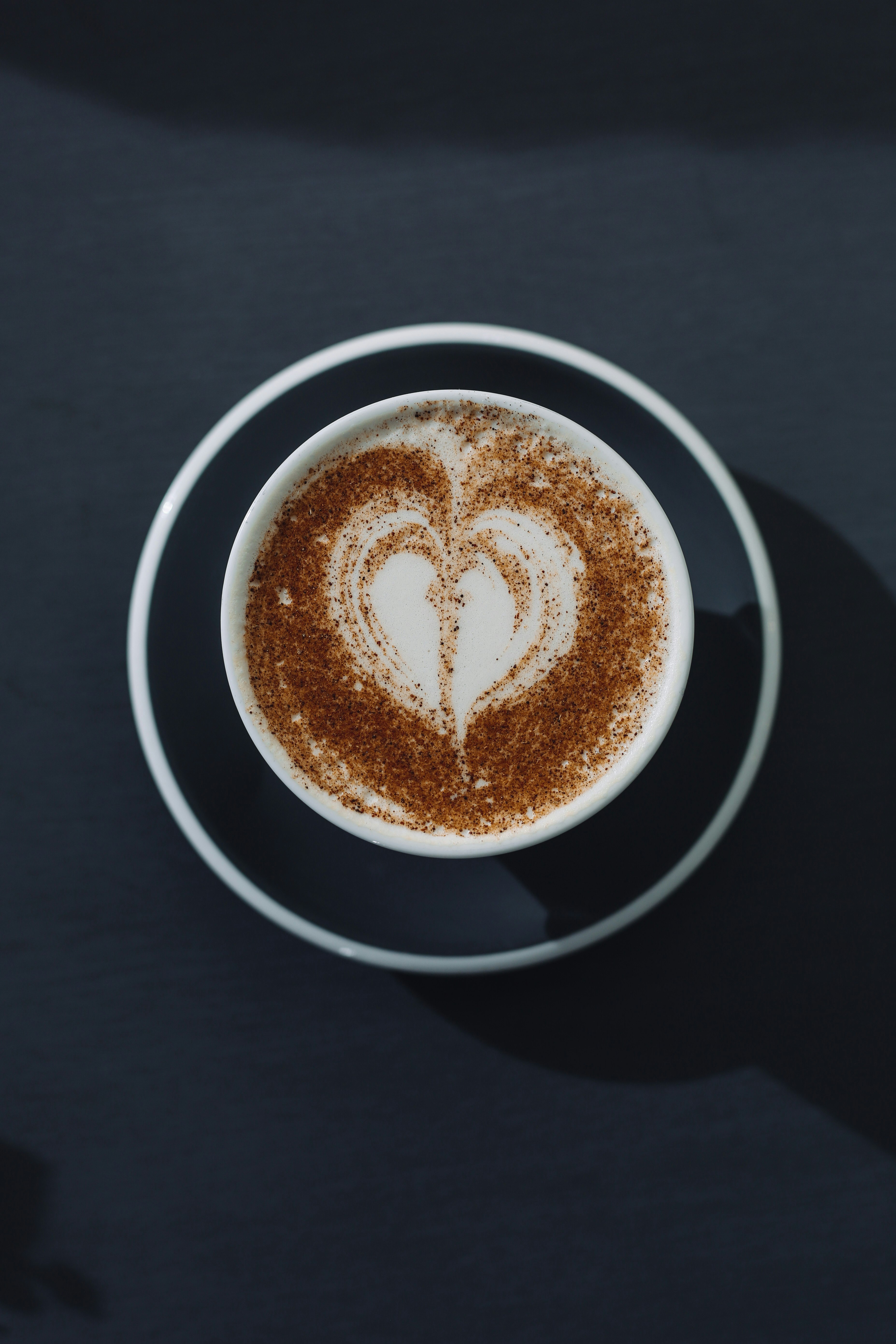 white ceramic mug with brown liquid