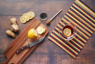 sliced lemon on chopping board beside knife and fork