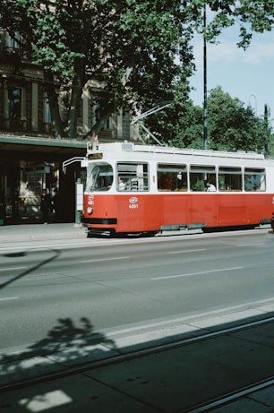 red and white tram on road during daytime