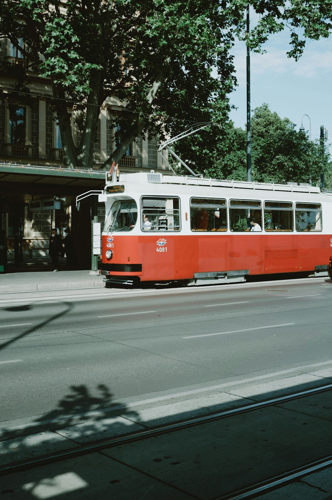 red and white tram on road during daytime