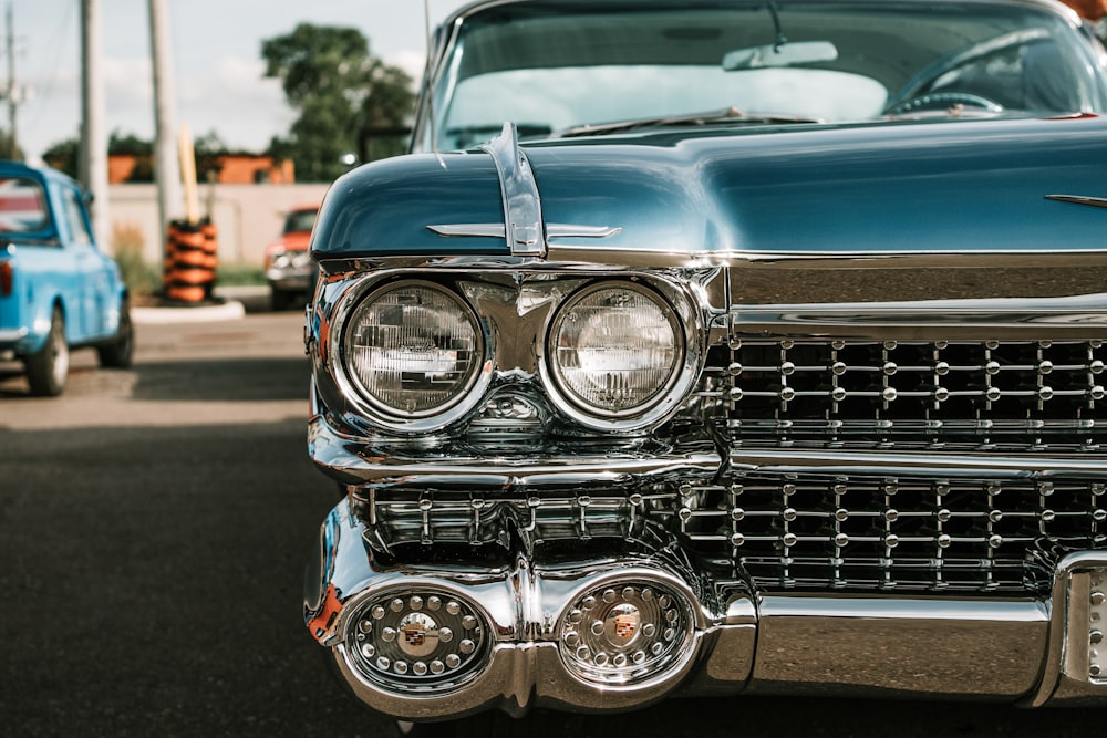 blue classic car on road during daytime