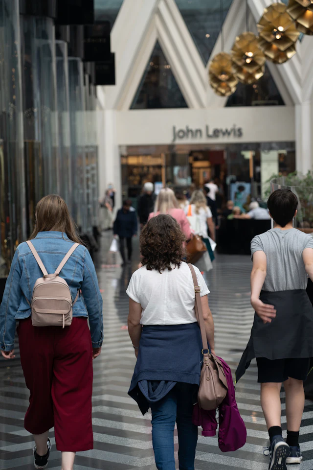 People walking along a street in Leeds city centre on a sunny day