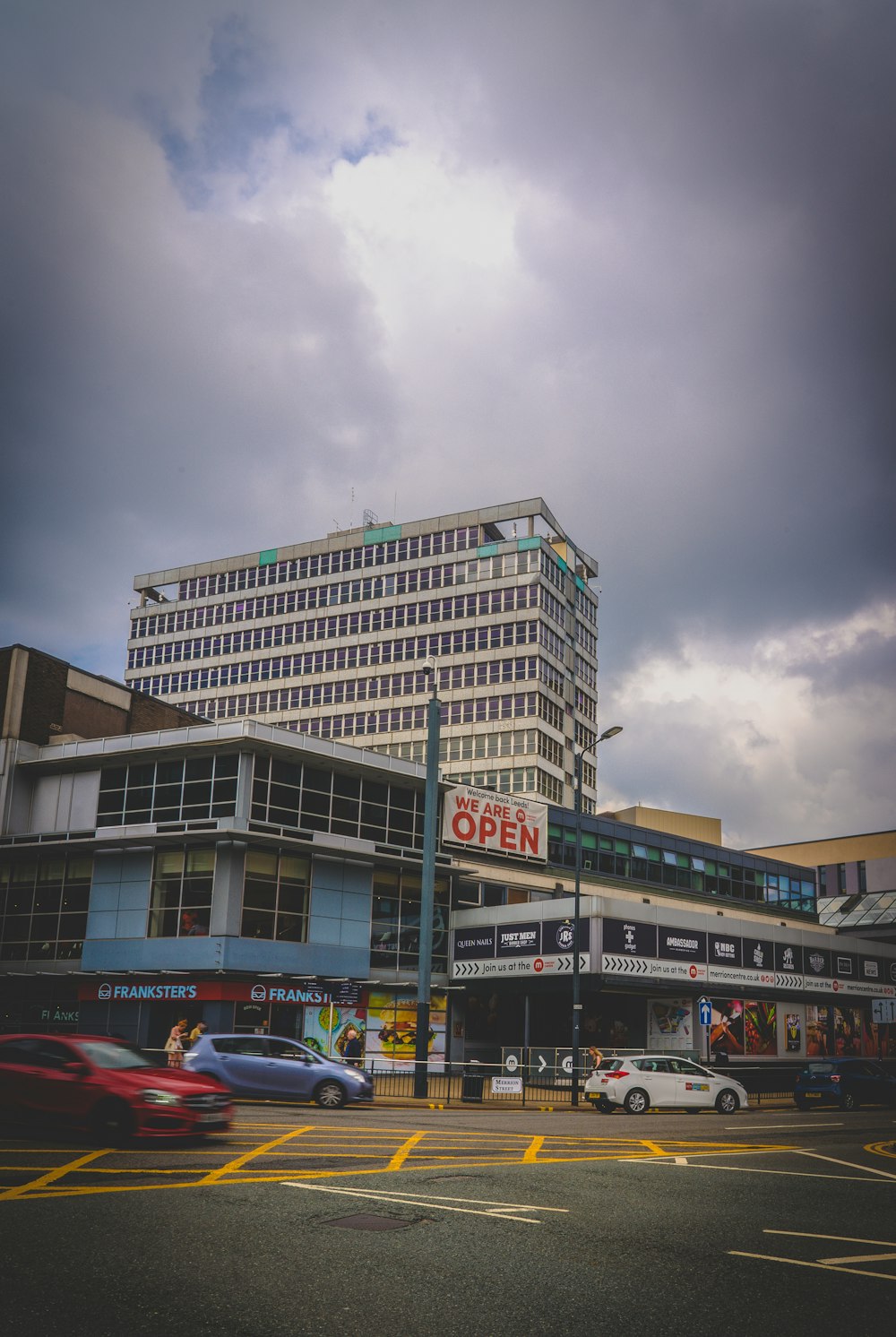 cars parked in front of building during daytime