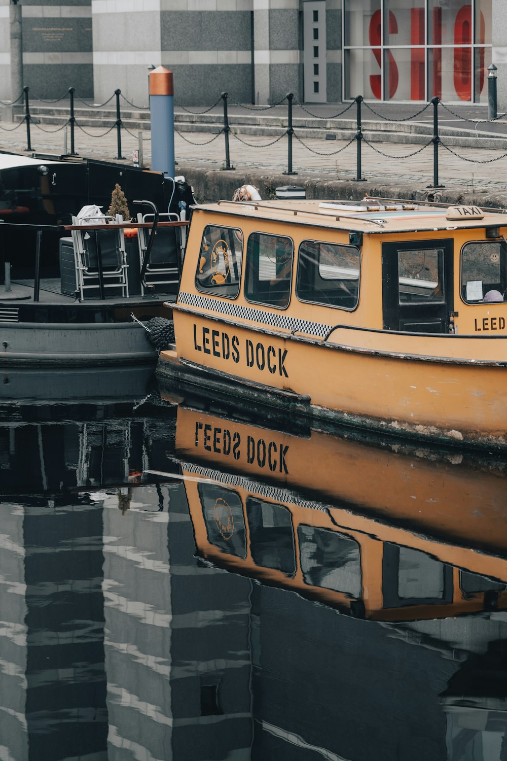 yellow and black boat on dock during daytime