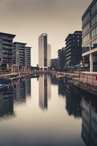 body of water between buildings during daytime