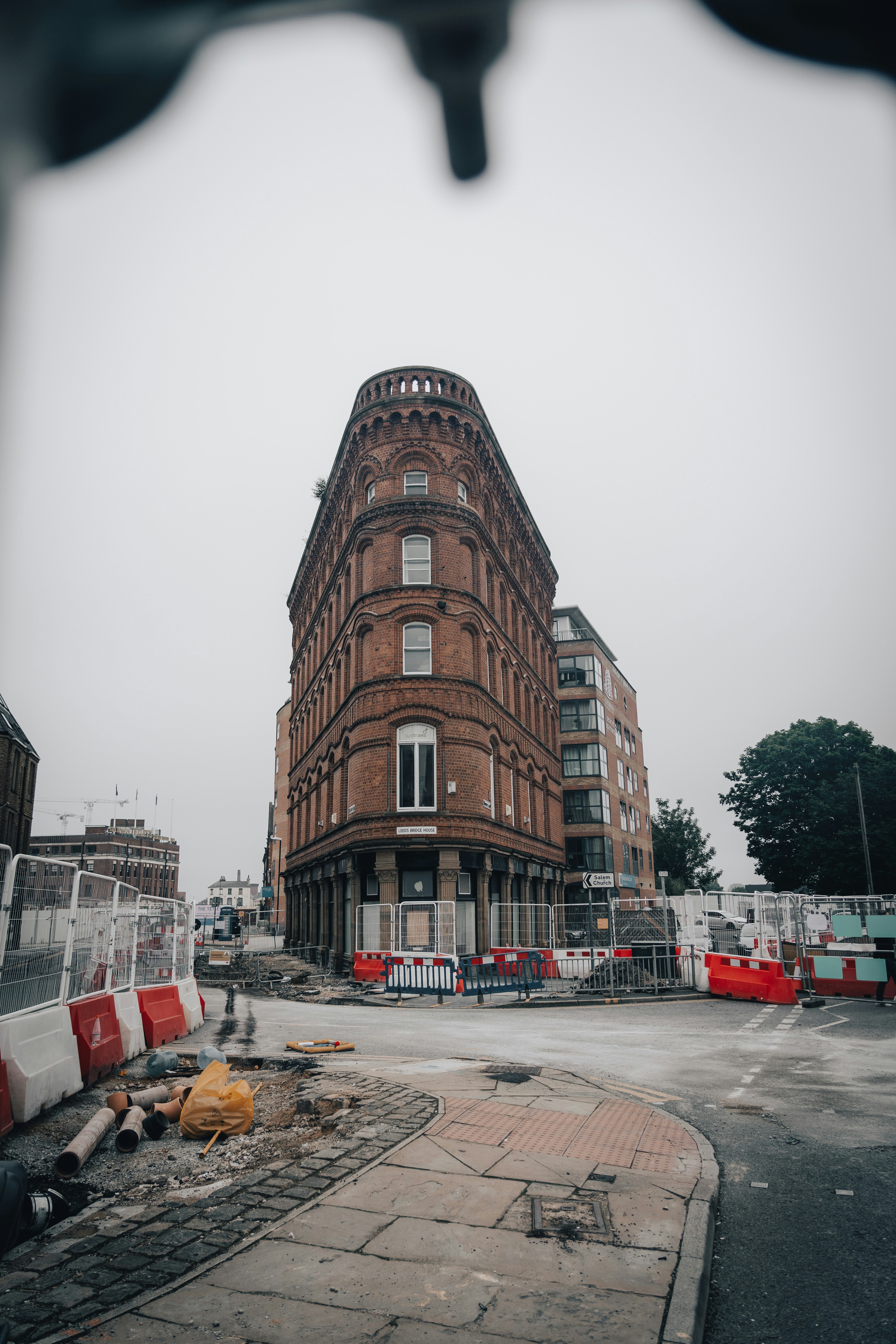 cars parked beside brown concrete building during daytime