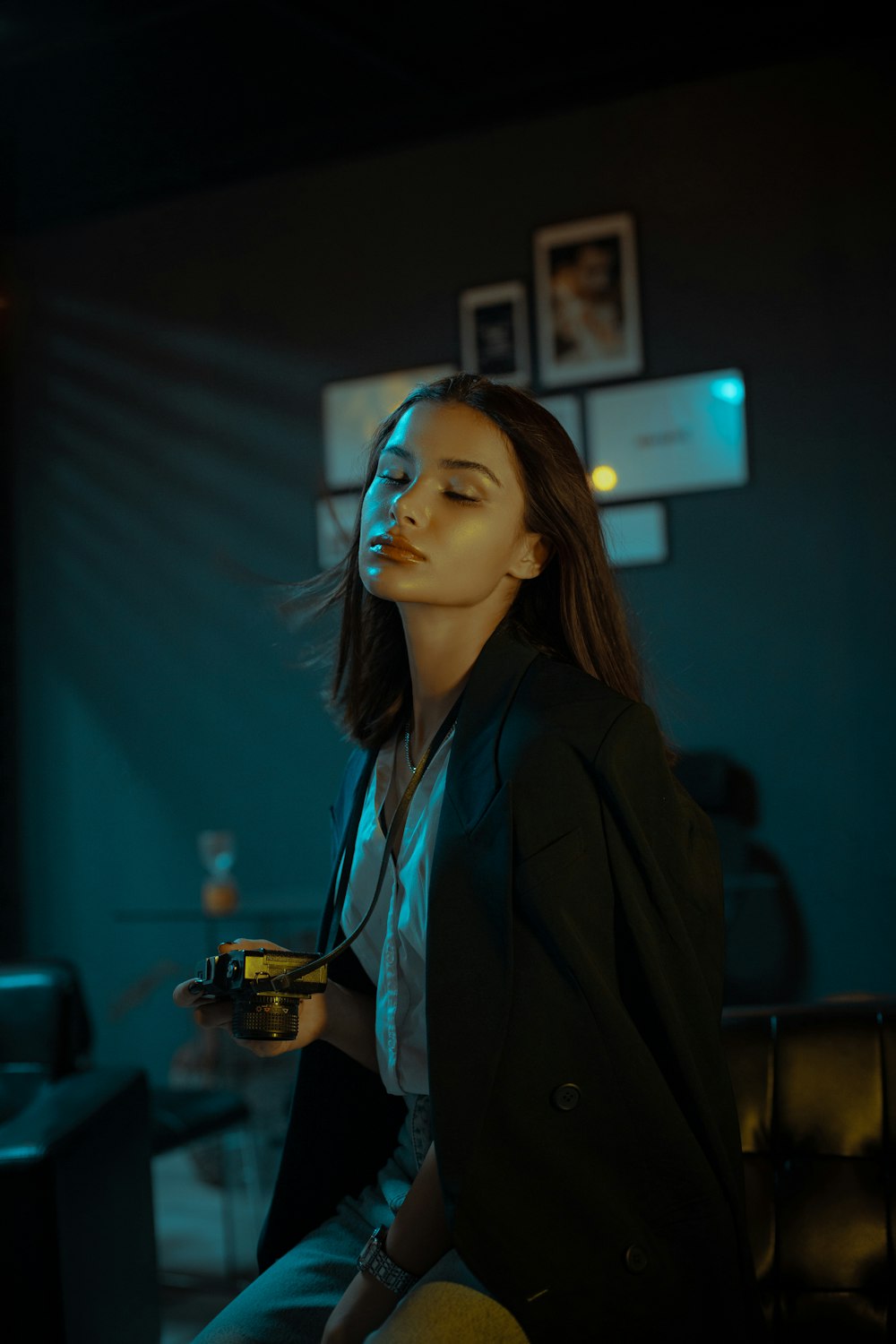 woman in black blazer standing near black flat screen tv