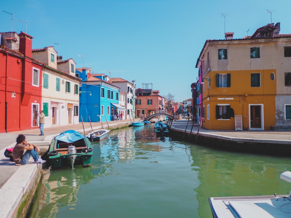 boat on river near houses during daytime