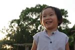 smiling girl in blue and white stripe shirt