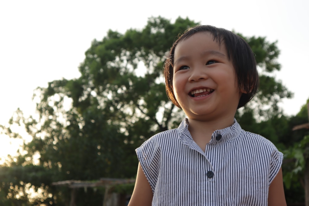 smiling girl in blue and white stripe shirt