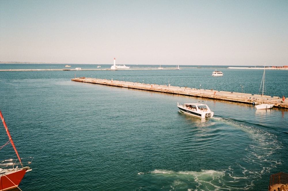 white and black boat on sea during daytime