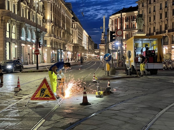 Emergency electrical repair work underway on a busy NYC storefront at dusk.