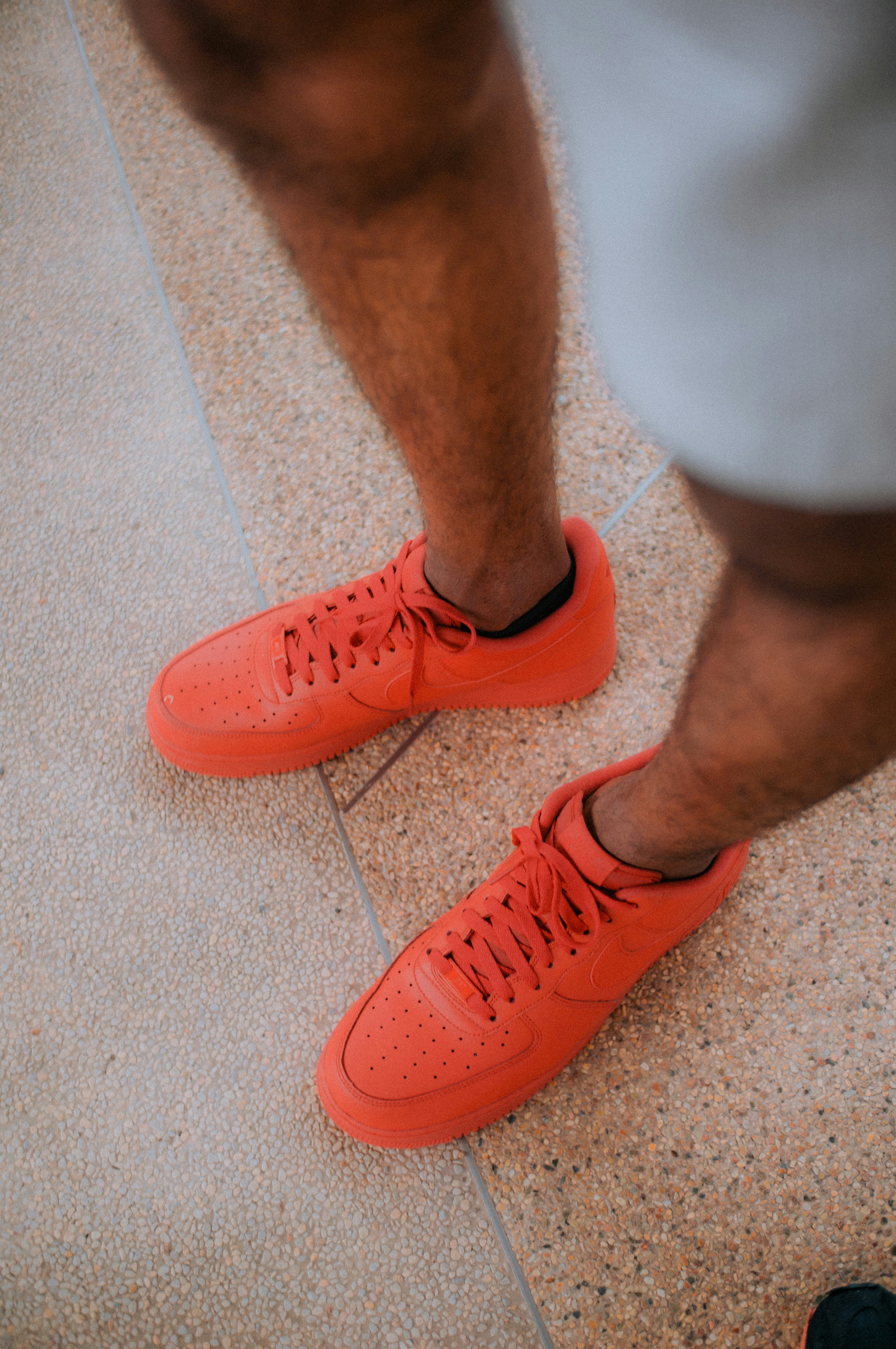 person wearing orange nike sneakers