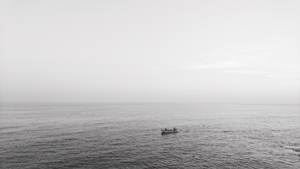 boat on sea under white sky during daytime