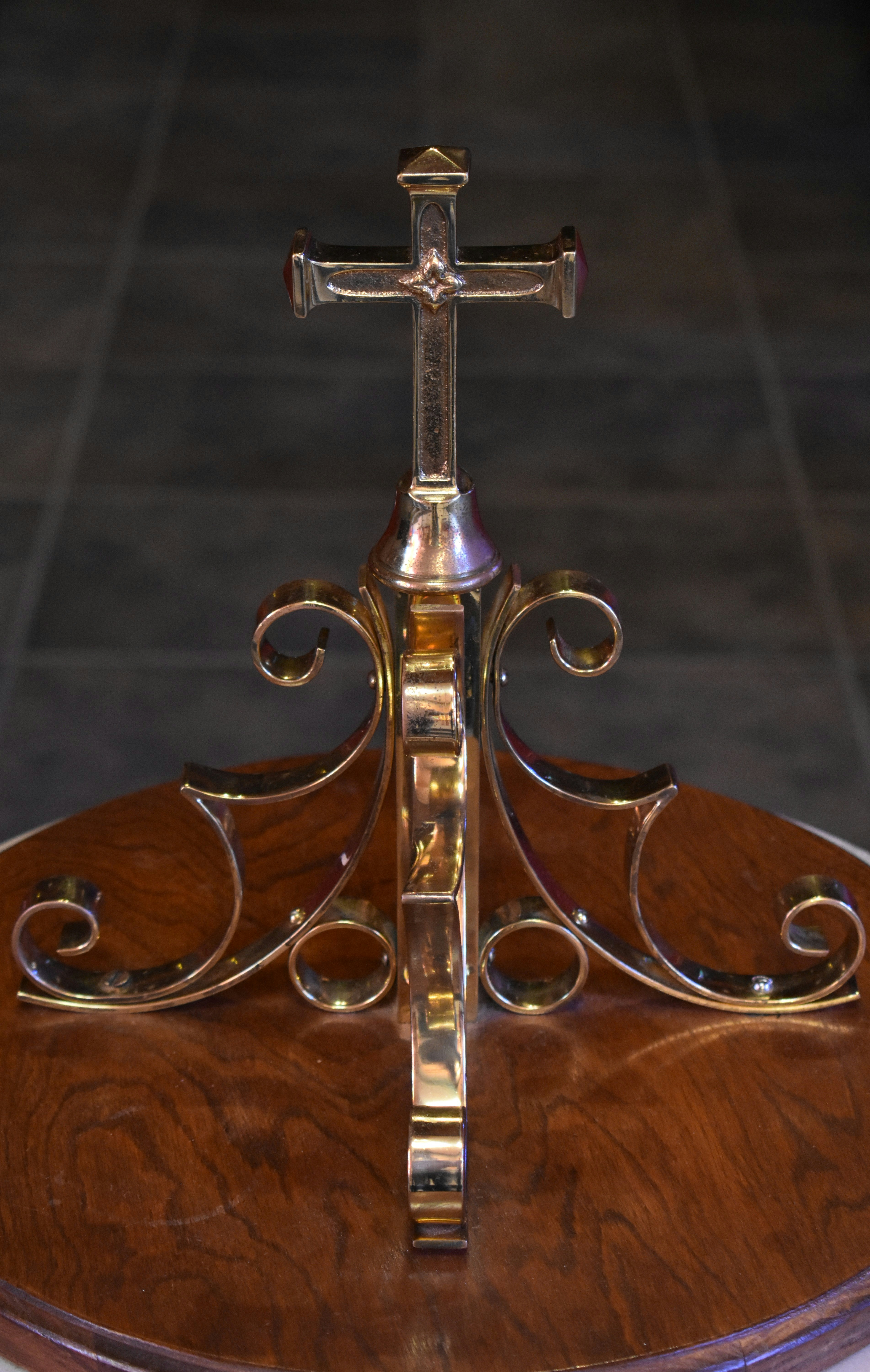 gold cross on brown wooden table