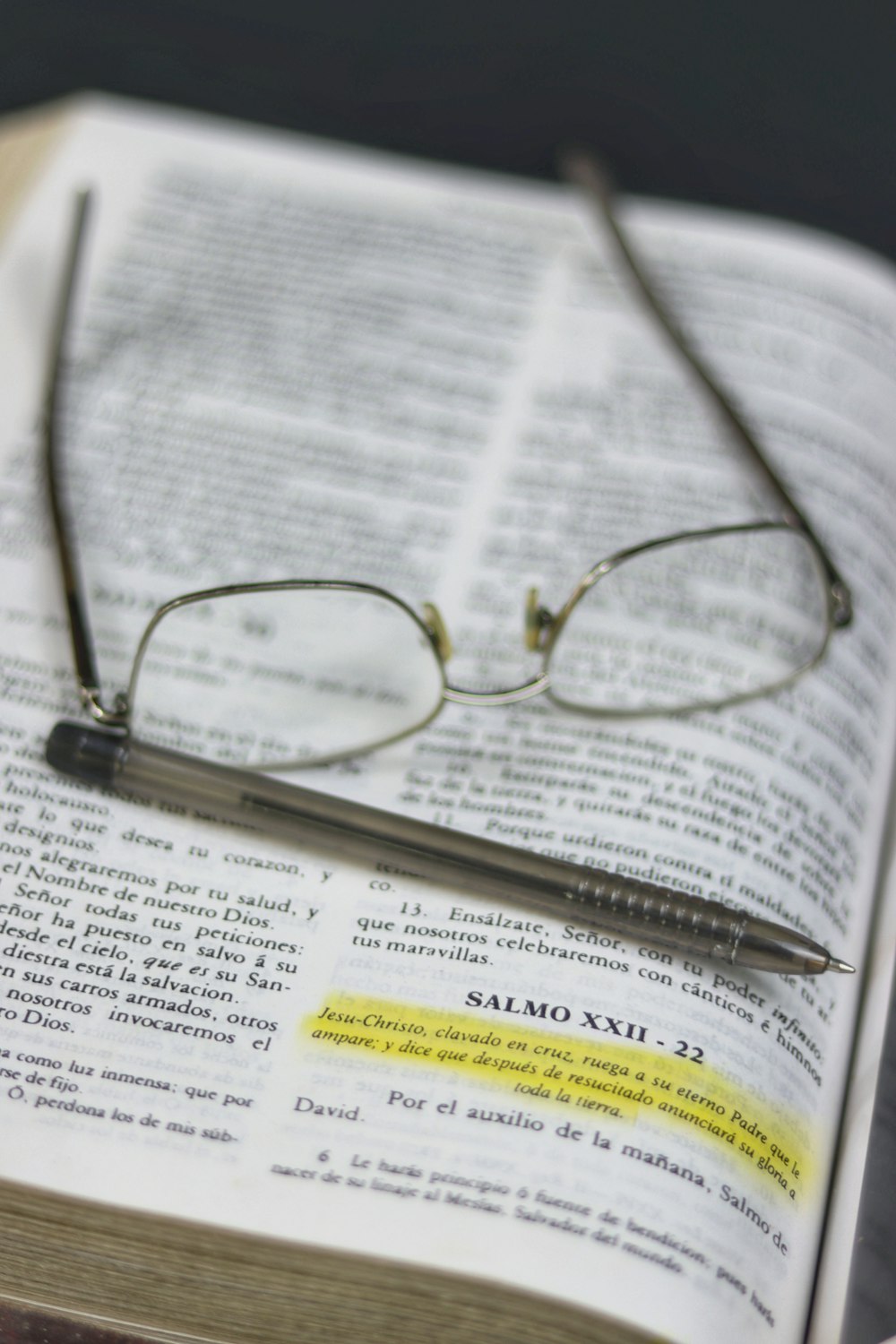 silver framed eyeglasses on white printer paper