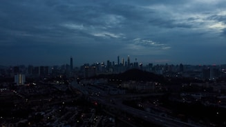 City skyline with connected digital network overlay at dusk