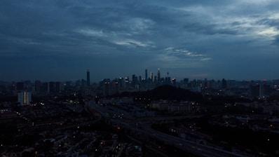 City skyline with connected digital network overlay at dusk