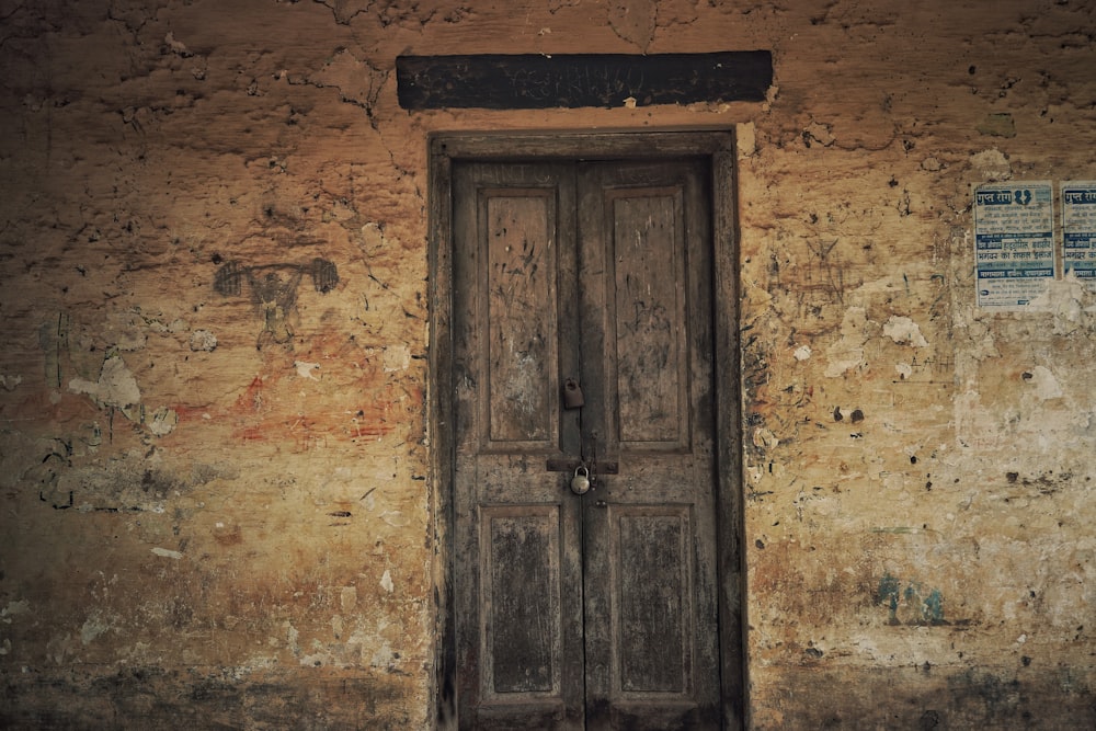 brown wooden door on brown concrete wall