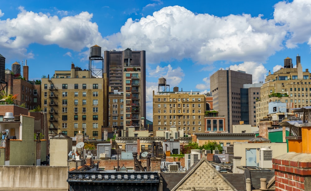 high rise buildings under blue sky and white clouds during daytime