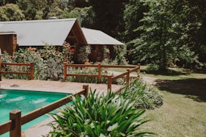 brown wooden gazebo near swimming pool during daytime