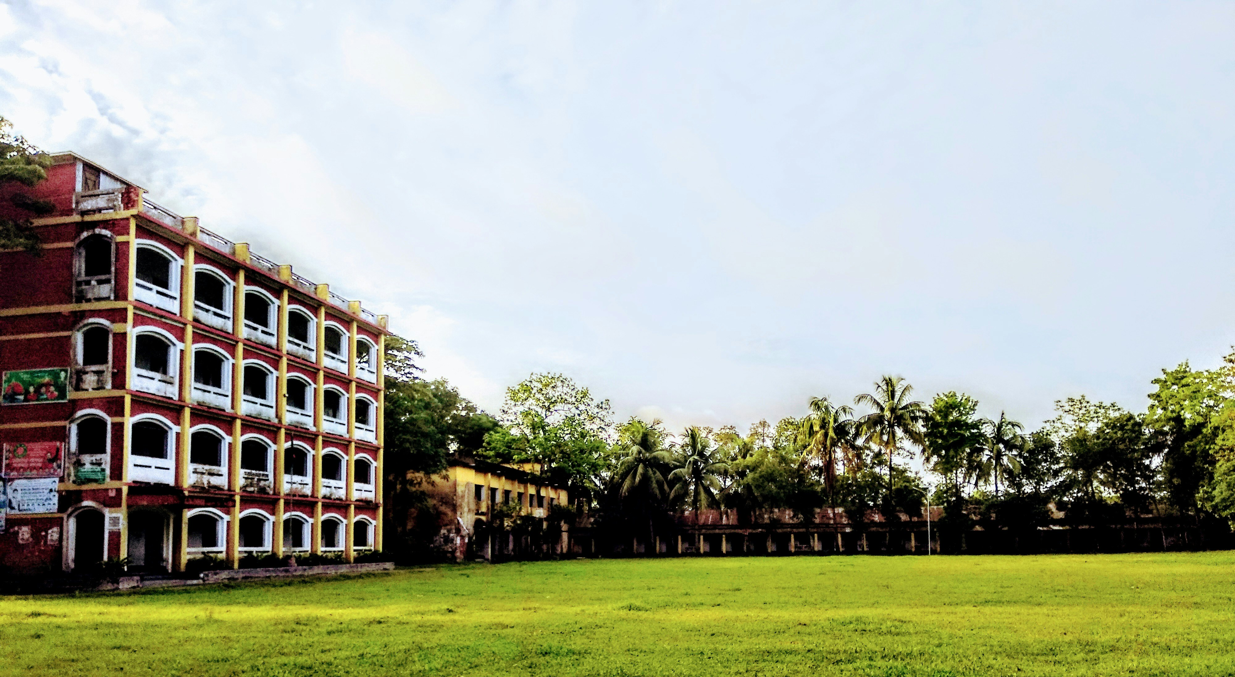 brown concrete building near green grass field during daytime