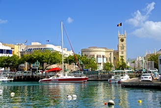 white and red boat on water near brown concrete building during daytime