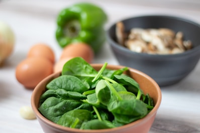 green vegetable on white ceramic bowl