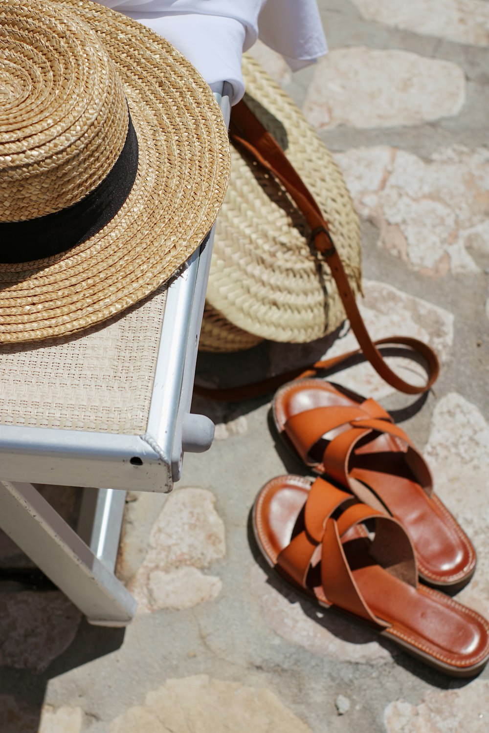 brown woven hat on white table