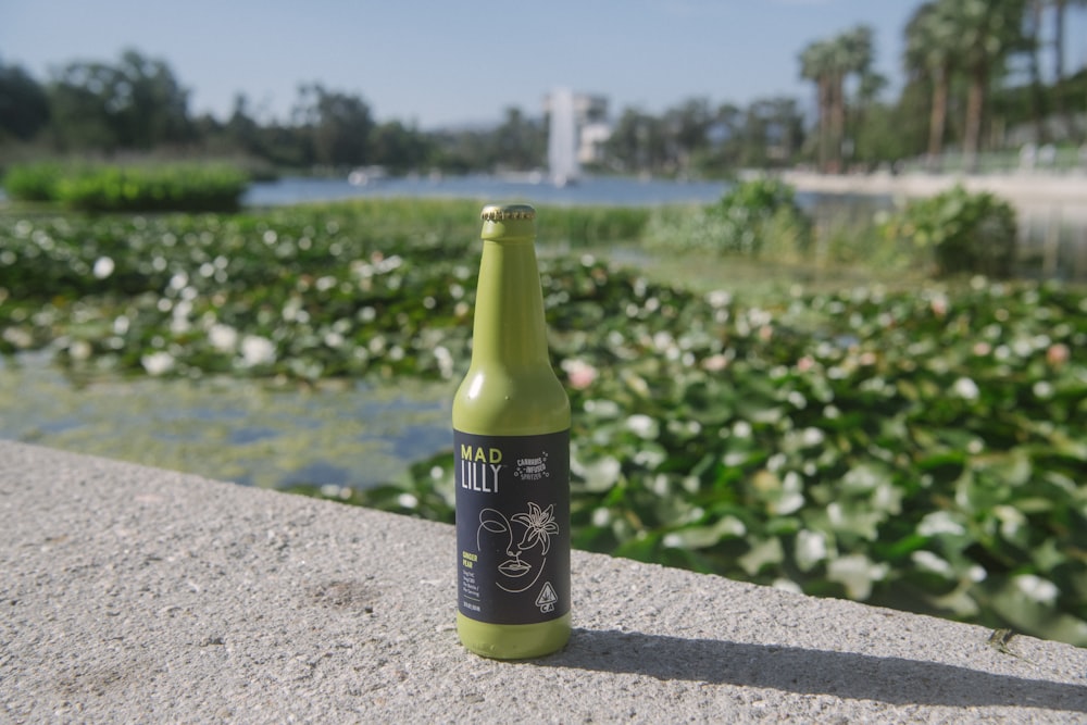 black and white labeled bottle on gray concrete surface