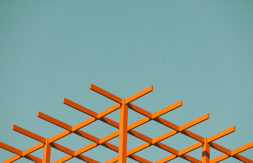 orange metal frame under blue sky during daytime
