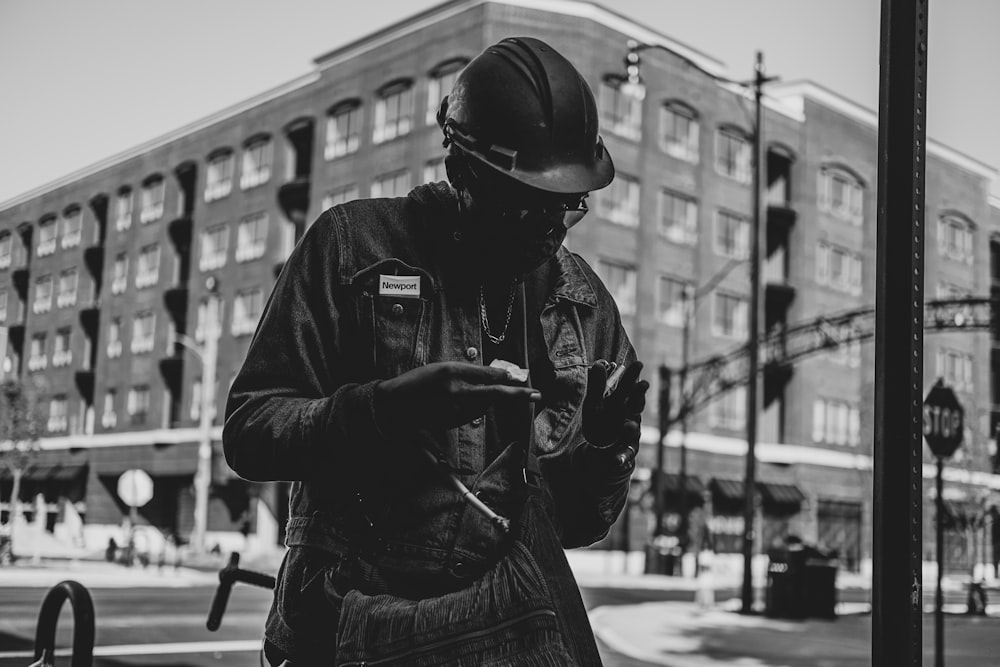 grayscale photo of man in jacket and helmet