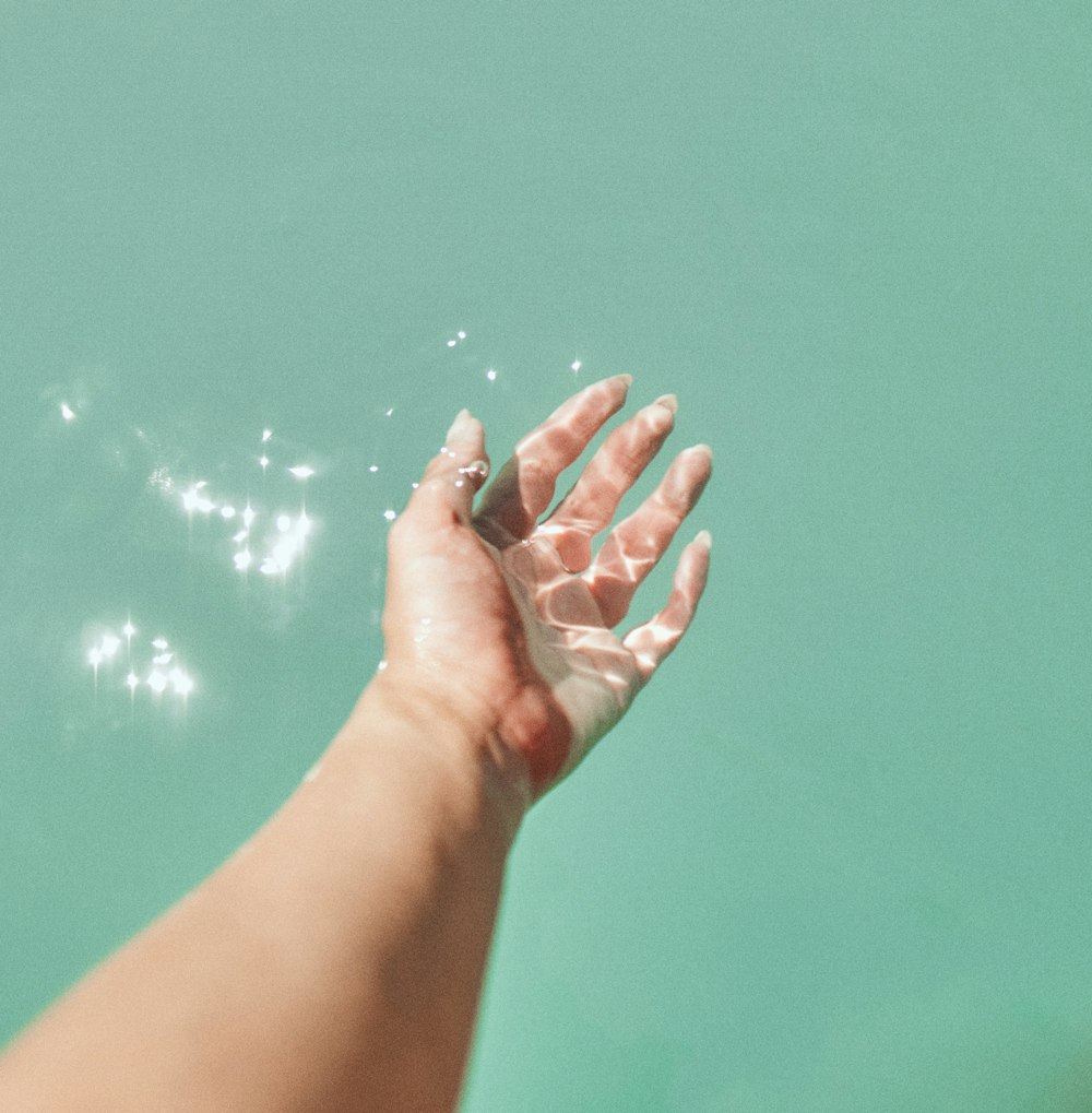 persons left hand on water