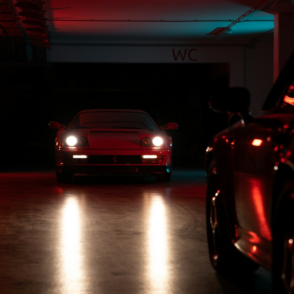 red car in front of white building