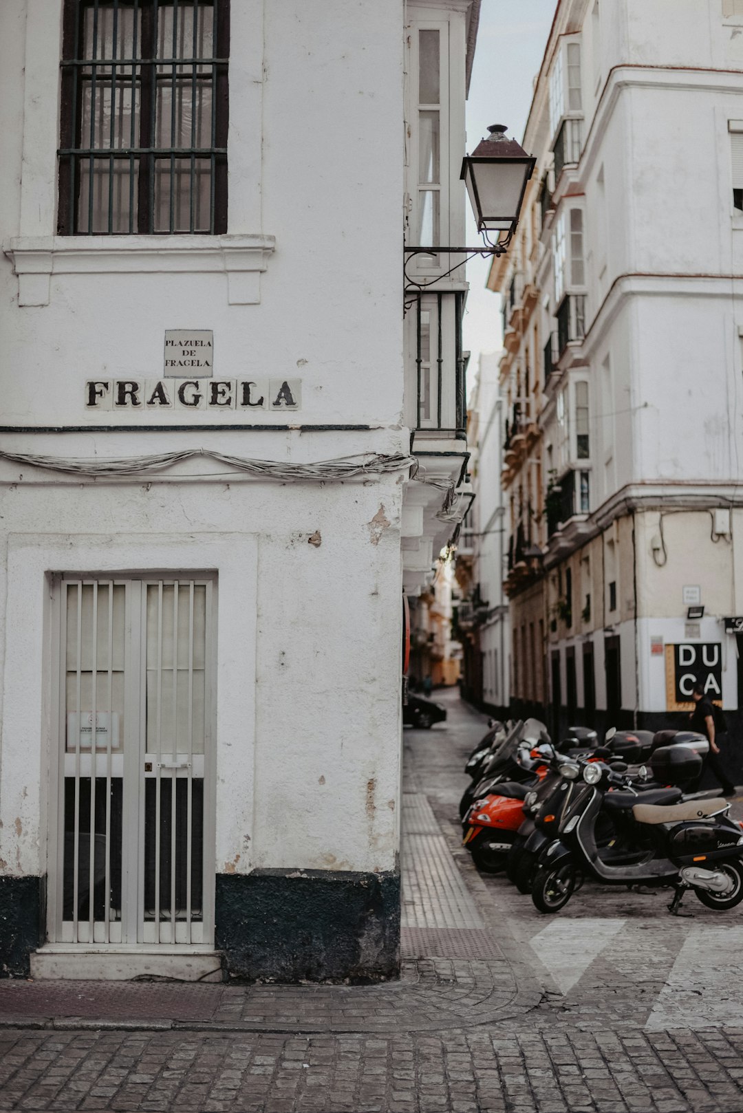 black motorcycle parked beside white concrete building