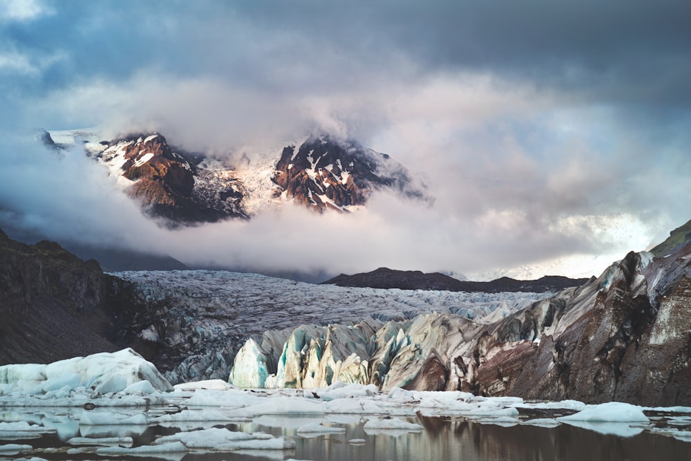 snow covered mountain under cloudy sky during daytime