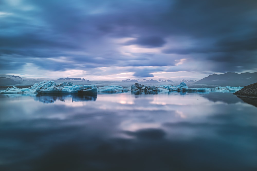 snow covered mountain under cloudy sky during daytime