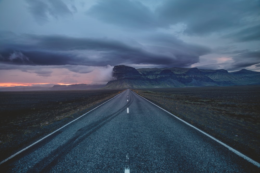 black asphalt road under gray sky