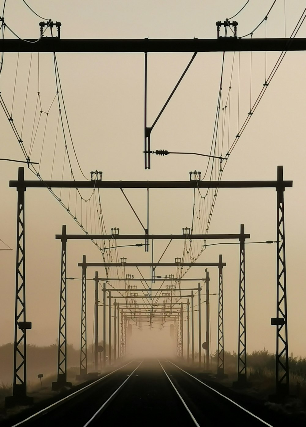 silhouette of electric post during sunset