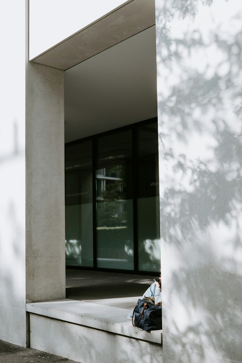 white concrete wall near glass window