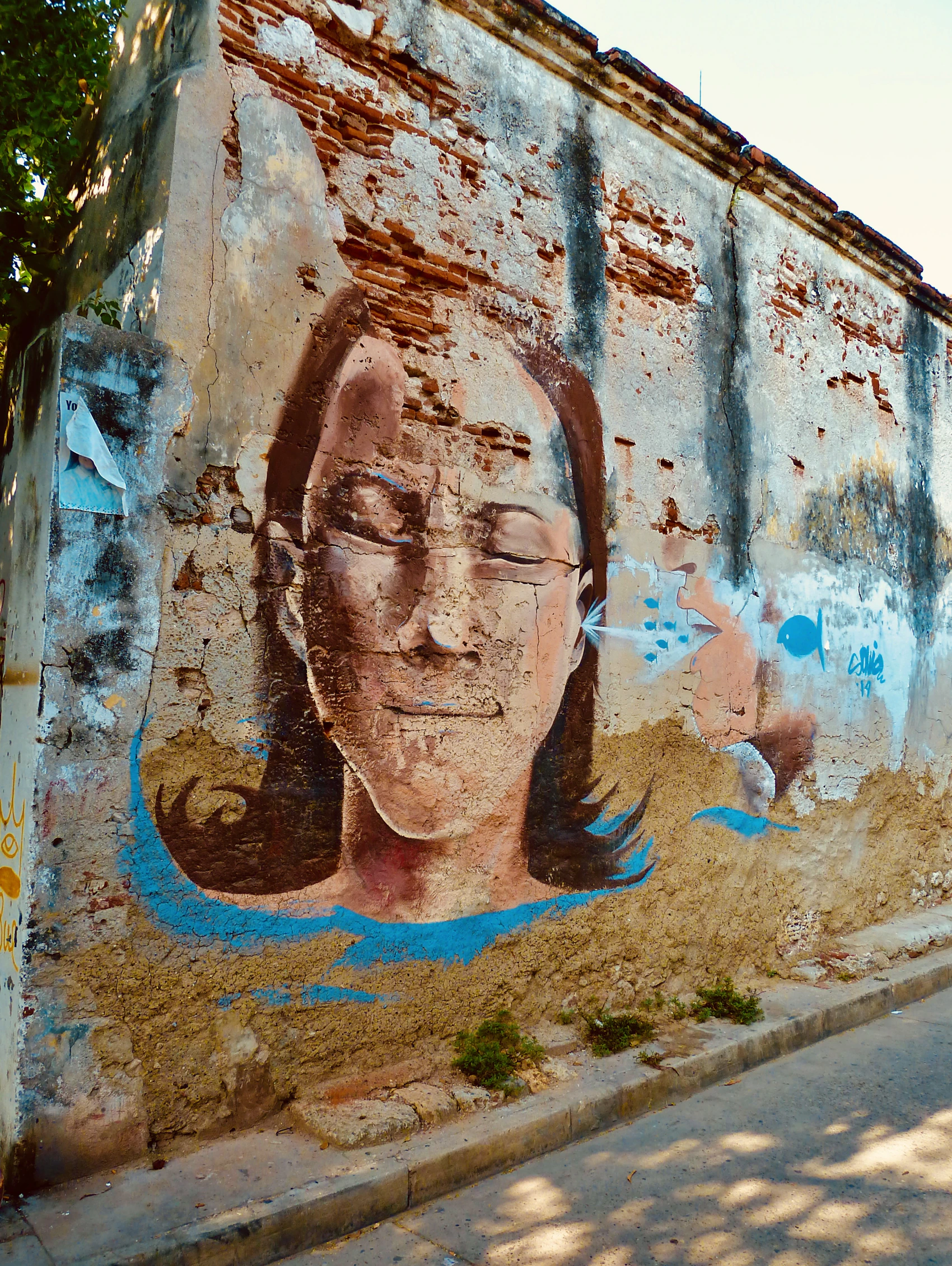 A large painted portrait on a weathered wall in Cartagena